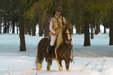 The brunette on a pony in the forest