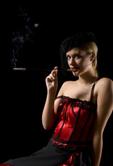 Attractive cabaret girl smoking a sigarette with an extension