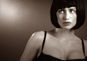 Naklejka premium Beautiful Brunette woman in Black Lingerie on Grey