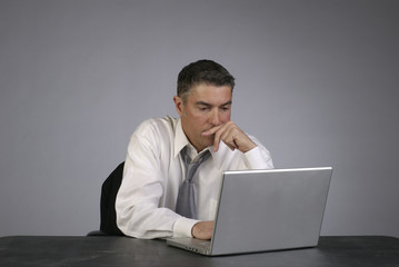 Businessman Looks at Computer