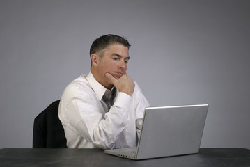Businessman Contemplates with Computer