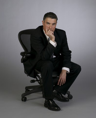 Businessman looks serious in office chair