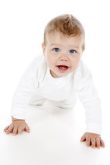 A cute baby boy crawling across the floor