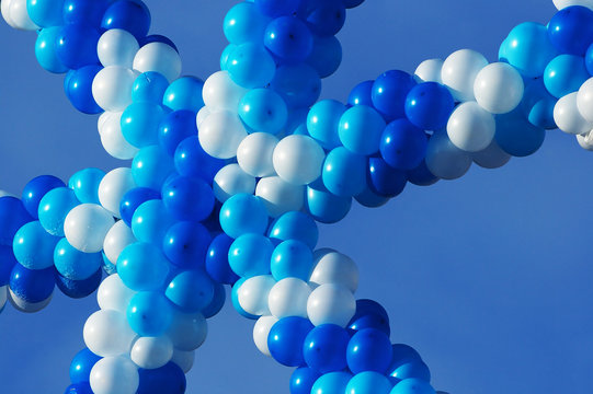 White and blue balloons on a background of the sky