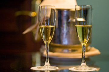 champagne glasses and bottle in hotel suite for celebration