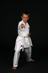Fototapeta na wymiar Young boy in glasses practicing traditional karate