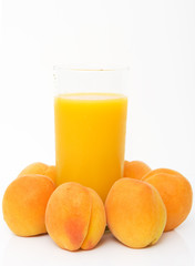 studio shot of fresh apricots with glass of juice