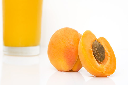 studio shot of fresh apricots with juice