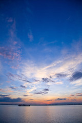 Fototapeta na wymiar beautiful sunrise at the sea horizon with cloudy sky