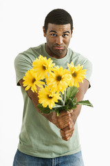 Pouting man holding bouquet.