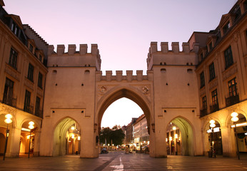 Towers with arches in street  European city in evening. Munich.