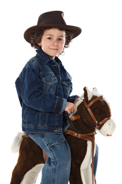 Child mounted on a wooden horse on a white background