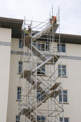 A tall set of stairs built of scaffolding at a construction site