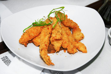 deep fried fish fillet served in a dish.