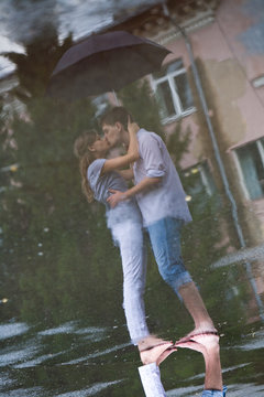 Image of reflection of man and woman kissing