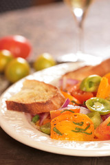 Colorful and Bright Tomato and Onion Salad With a Slice of Bread