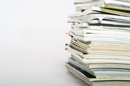 Stack of magazines on neutral background closeup