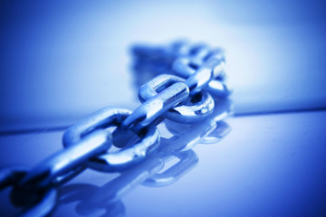 An isolated steel chain on a blue background.