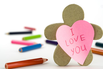 Obraz premium heart shaped note paper, figure and pencils on white background