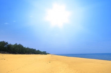wide empty summer beach with brightly shining sun