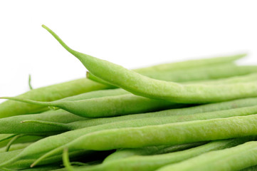 Closeup of green french beans over white background