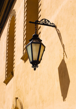 Ancient street lamp on the wall in sunny day