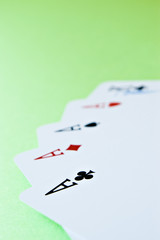 playing cards (four Aces) with shallow depth of field on green