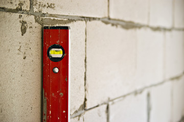 red balance level and wall with shallow depth of field