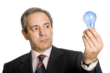 mature business man with a lamp isolated on white