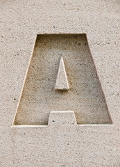 Letter A carved in a stone block.