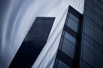 Fototapeta na wymiar Detail of modern skyscraper. Psychodelic sky.