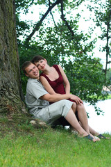 happy young couple relaxing near the river