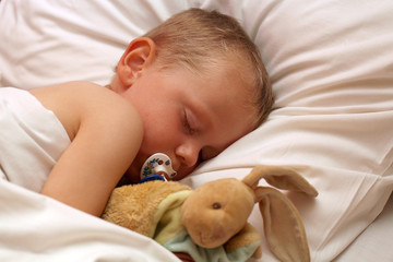 Petit garçon dormant avec son doudou