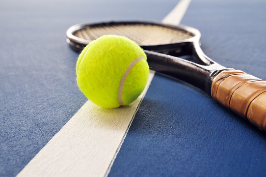 Tennis ball and racquet on the court