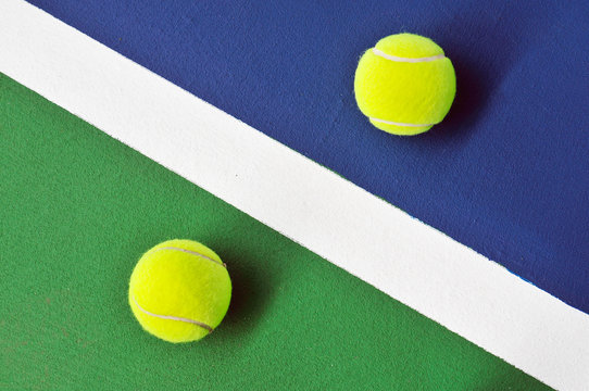 Two tennis balls just on the line