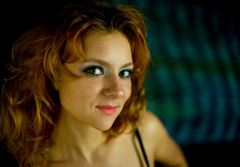 Fototapeta premium Red hair female's portrait on the fantasy light background