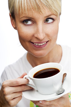 young blond woman drinking coffee close up