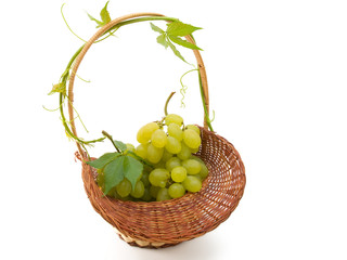 basket with grapes isolated on white