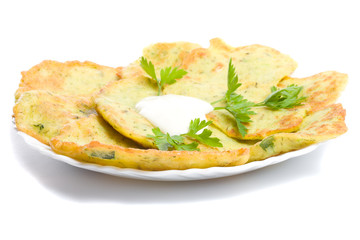 pancake from marrow with parsley on plate