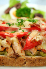 Grilled open chicken sandwich with avocado and peppers