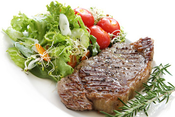 Grilled steak with salad.  Porterhouse or New York strip steak