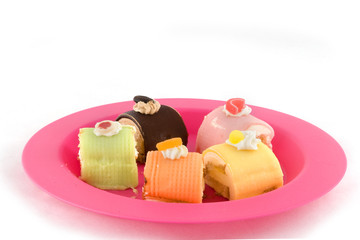 Fancy marzipan cakes on pink