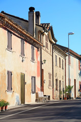 Fototapeta na wymiar rural Italy - old houses lining a street in early sun