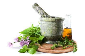 Herbs with mortar and bottle with oil
