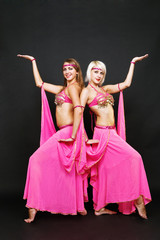 two smiley dancers over dark background