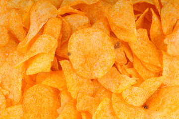 Background made of golden fried potato chips.