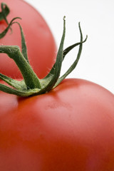 Macro of two red tomatoes.