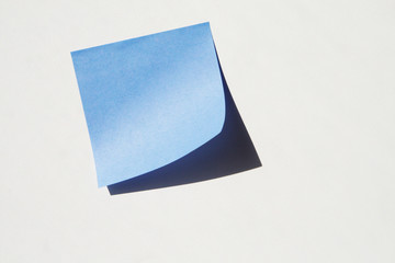 blue sticky note on the grey wall