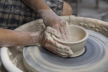 A potter works on a bowl at the Laguna Sawdust Art Festival.
