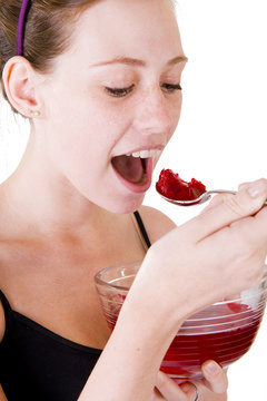 A Teenage Girl Eating Red Jello Or Jelly.